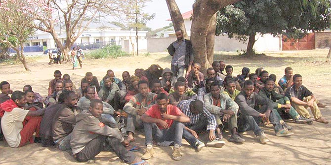 Ethiopian migrants who were arrested by the police, await trial outside the Karonga Court in Malawi, in September 2014. Photo credit: Tiwonge Kumwenda, VOA