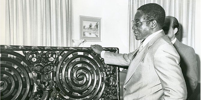 Robert Mugabe, then Prime Minister of Zimbabwe, admires a Maori carving, a gift from the government of New Zealand, during his country's independence celebrations on 18 April 1980 Photo Credit: Archives New Zealand via Flickr (http://bit.ly/2j8UUjz) CC BY-SA 2.0
