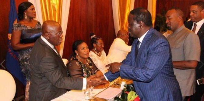 Ghana President Nana Akufo-Addo shakes hands with Kenya opposition leader Raila Odinga during his inauguration