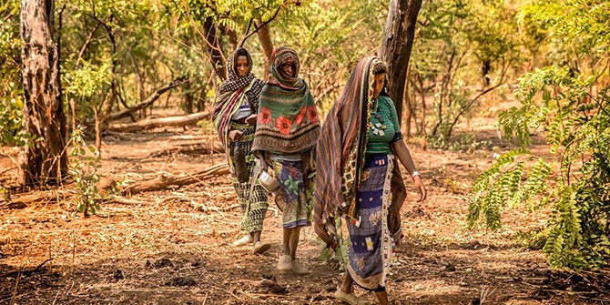 Peuhl women walk to their camp in the forest around Ndele