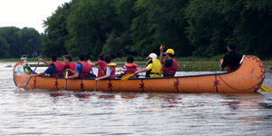 Volunteers oversee kids paddling a Rabaska as part of a day camp in Montreal (credit: Zena Xing)