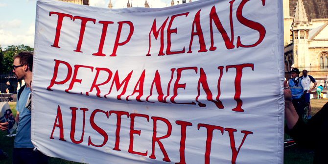 Protestors hold a banner which says, “TTIP means permanent austerity”