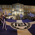 Supporters of Greece's far-right Golden Dawn party protest around a flag during a rally at central Syntagma square in Athens November 30, 2013. Hundreds of supporters gathered outside parliament on Saturday to protest the pre-trial detention of their leader Nikolaos Mihaloliakos, who faces charges of forming a criminal organisation. REUTERS/Yorgos Karahalis (GREECE - Tags: POLITICS CIVIL UNREST) - RTX15YYG