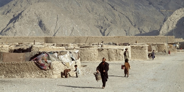 Afghan refugees in Quetta, Pakistan, who live outside of the formal system of refugee camps. The hills in the background are Jurassic limestone.